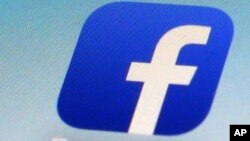 FILE - A Facebook app icon is shown on a smartphone in New York.