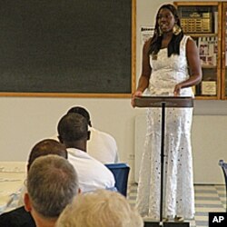 Scholarship winner Tomi Dare speaks to inmates.