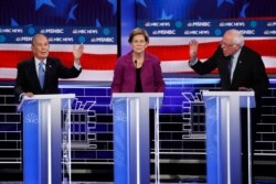 From left, Democratic presidential candidates, former New York City Mayor Mike Bloomberg, Sen. Elizabeth Warren, D-Mass., Sen. Bernie Sanders, I-Vt., participate in a Democratic presidential primary debate, Feb. 19, 2020, in Las Vegas.
