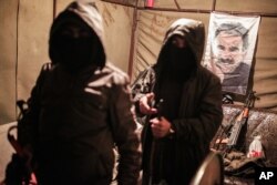 Militants of the Kurdistan Workers' Party, or PKK, stand in a bunker in Sirnak, Turkey, Dec. 23, 2015.