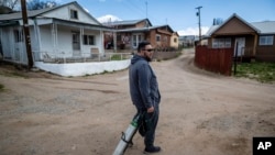 Angelo Sandoval, 'mayordormo' or caretaker of the 1830s San Antonio Church, stands on a dirt road in Cordova, New Mexico, April 14, 2023.