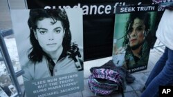 Signs in support of Michael Jackson are seen outside of the premiere of the 'Leaving Neverland' Michael Jackson documentary film at the Egyptian Theatre on Main Street during the 2019 Sundance Film Festival, Jan. 25, 2019, in Park City, Utah.
