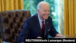 USA, Washington, U.S. President Joe Biden smiles after signing executive orders strengthening access to affordable healthcare