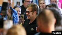 FILE - British musician Elton John (C) attends a charity event to support innovative HIV prevention and to raise awareness about AIDS in Kyiv, Ukraine, May 28, 2018.