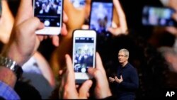 FILE - Apple CEO Tim Cook announces the new iPhone 7 during an event to announce new products, in San Francisco. 