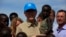 U.N. Secretary-General Ban Ki-moon (C) carries a child displaced by the region's conflict during his visit to an IDP (internally displaced persons) camp in the United Nations Mission in South Sudan (UNMISS) base at Thong Ping in Juba, May 6, 2014.