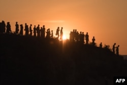 FILE - Rohingya Muslim refugees walk down a hillside in the Kutupalong refugee camp in Cox's Bazar on November 26, 2017.