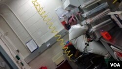 USAMRIID scientist Ana Kuhene works with samples of Ebola in a specially equipped lab at Fort Detrick in Maryland, where the most deadly pathogens are handled on Dec. 11, 2014. (VOA/C.Maddux)