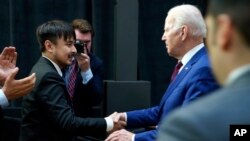 Brandon Tsay shakes hands with President Joe Biden after he spoke on efforts to reduce gun violence at The Boys & Girls Club of West San Gabriel Valley, March 14, 2023, in Monterey Park, California. 