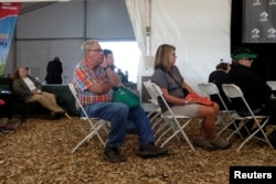 A group of people sit and watch a presentation on agricultural economics at the 2018 Farm Progress Show in Boone, Iowa, U.S., August 29, 2018. Picture taken on August 29, 2018. REUTERS/Jordan Gale