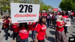 Protesters march in front of the Nigerian embassy in northwest Washington, Tuesday, May 6, 2014, protesting the kidnapping of nearly 300 teenage schoolgirls, abducted from a school in the remote northeast of Nigeria three weeks ago.
