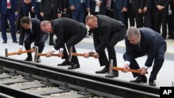 Turkey's President Recep Tayyip Erdogan, 2nd left, Azerbaijan's President Ilham Aliyev, 2nd right and Georgia's Prime Minister Giorgi Kvirikashvili, right, inaugurate the Baku-Tbilisi-Kars railway, at a ceremony in Baku, Azerbaijan, Oct. 30, 2017. 