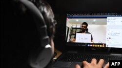 A boy watches "I For India" concert live on Facebook during a government-imposed nationwide lockdown as a preventive measure against the COVID-19 coronavirus, in Ghaziabad on May 3, 2020.