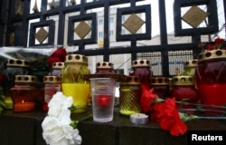 Candles, flowers, a piece of bread and a glass of vodka are placed in memory of passengers and crew members of Russian military plane, which crashed into the Black Sea on its way to Syria on Sunday.