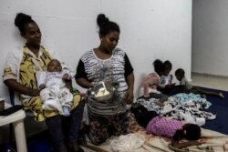 An Israeli family rests inside a bomb shelter at the coastal city of Ashkelon, Israel, Nov. 13, 2019.