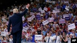 Republican presidential candidate Donald Trump waves to the crowd as he arrives at a campaign rally in North Carolina. He made controversial remarks about Hillary Clinton. (AP Photo/Evan Vucci)