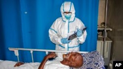FILE - A medic tends to a patient in a coronavirus ward at Martini Hospital, in Mogadishu, Somalia, May, 13, 2020.