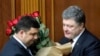 FILE - Ukraine's President Petro Poroshenko, right, and Volodymyr Groysman celebrate after Groysman was appointed prime minister during a parliament session in Kyiv, Ukraine, April 14, 2016, after lawmakers endorsed Arseniy Yatsenyuk’s resignation.