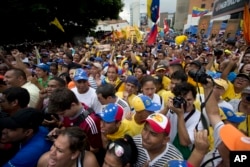 People chant against the government of President Nicolas Maduro during a march in Caracas, Venezuela, May 14, 2016. Protesters demanded electoral officials accelerate the certification of the petition signatures that would kick off a recall of Maduro.