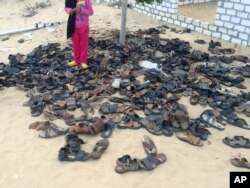 Discarded shoes of victims remain outside al-Rawda mosque in Bir al-Abd, northern Sinai, Egypt, a day after attackers killed hundreds of worshipers, Nov. 25, 2017.