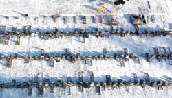 A worker digs a grave in a cemetery amid the coronavirus disease (COVID-19) outbreak in Manchester, Britain, Jan. 25, 2021. Picture taken with a drone.