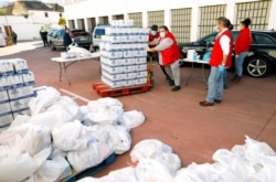 Members of the Spanish Red Cross prepare food for families in need at a food bank during the COVID-19 outbreak in Ronda, southern Spain, April 3, 2020.