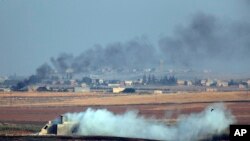 In this photo taken from the Turkish side of the border between Turkey and Syria, in Akcakale, Sanliurfa province, southeastern Turkey, smoke billows from targets inside Syria during bombardment by Turkish forces Wednesday, Oct. 9, 2019.