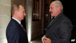 FILE - Russian President Vladimir Putin, left, and Belarusian President Alexander Lukashenko meet in the Bocharov Ruchei residence in the Black Sea resort of Sochi, Russia, Sept. 15, 2015.