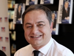 FILE - Gokmen Ulu, a Turkish journalist working for the pro-secular opposition Sozcu newspaper, attends a book signing in Ankara, Dec. 21, 2019.