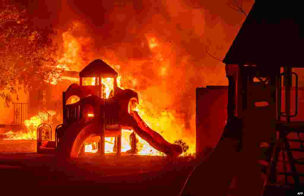 A playground burns in a residential neighborhood during the Eaton fire in Pasadena, California, Jan. 7, 2025.
