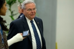 FILE - Sen. Bob Menendez talks to reporters on Capitol Hill in Washington, Jan. 28, 2020.