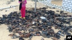 FILE - Discarded shoes of victims remain outside al-Rawdah mosque in Bir al-Abed, northern Sinai, Egypt, a day after attackers killed hundreds of worshippers, Nov. 25, 2017.