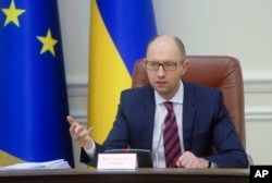 FILE - Ukrainian Prime Minister Arseniy Yatsenyuk speaks during Cabinet in Kyiv, Ukraine, Nov. 25, 2015.