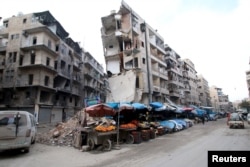 Stalls are seen on a street beside damaged buildings in the rebel held al-Shaar neighborhood of Aleppo, Syria, Feb. 10, 2016.