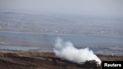 An Israeli tank maneuvers close to the ceasefire line between Israel and Syria on the Israeli-occupied Golan Heights, Nov. 13, 2012.