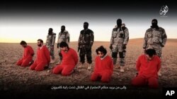 This undated image, taken from video posted online Jan. 3, 2016, by the communications arm of the Islamic State group, purports to show IS militants executing five men whom they accuse of having spied for Britain in Syria.