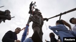 FILE - Thai people pay their respect to giant bronze statues of former King Ram Khamhaeng after a religious ceremony at Ratchapakdi Park in Hua Hin, Prachuap Khiri Khan province, Thailand. The park has been at the center of a corruption scandal.