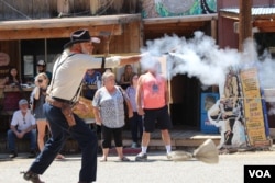 Actors perform a fake Wild West style shootout.
