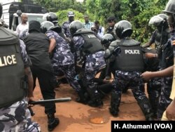 A male protester is arrested by Uganda police officers during a march against kidnappings and murders in Uganda, June 5, 2018.