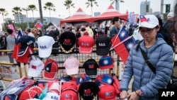 A street vender sells Taiwan flags and caps at a campaign rally of the main opposition Kuomintang (KMT) in Kaohsiung on Jan. 7, 2024, a week before the presidential election.