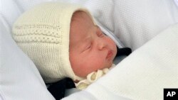 The newborn baby princess, born to parents Kate Duchess of Cambridge and Prince William, is carried in a car seat by her father from The Lindo Wing of St. Mary's Hospital, in London, May 2, 2015. 
