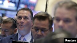 Traders work on the floor of the New York Stock Exchange in lower Manhattan, April 20, 2016.