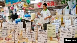 A Thai vendor weighs a bag of rice at a market in central Bangkok. 