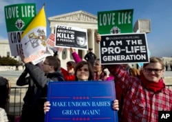FILE - Anti-abortion activists protest outside of the U.S. Supreme Court, during the March for Life in Washington, Jan. 18, 2019.