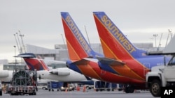 FILE - Southwest Airlines had the highest forced bumping rate among very large carriers, taking nearly 15,000 passengers off flights last year, or 9.9 per 100,000 passengers, down slightly from 2015. 