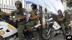 Soldiers patrol outside a polling station in Guatemala City, September 10, 2011.