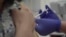 FILE - This screen grab taken from video issued by Britain's Oxford University shows a person being injected as part of the first human trials in the U.K. to test a potential coronavirus vaccine, April 23, 2020.