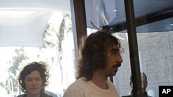 Freed American freelance journalist Clare Morgana Gillis, left and Spanish photographer Manu Brabo arrive to a hotel where most of international media stays in Tripoli, Libya, May 18, 2011.