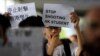 A protester holds a sign following a day of violence over an extradition bill that would allow people to be sent to mainland China for trial, in Hong Kong, June 13, 2019. 
