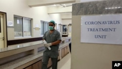 FILE - A Pakistani doctor enters an isolation ward set up as a preventive measure following the deadly coronavirus outbreak, at the Jinnah Postgraduate Medical Centre in Karachi, Pakistan, Feb. 3, 2020.